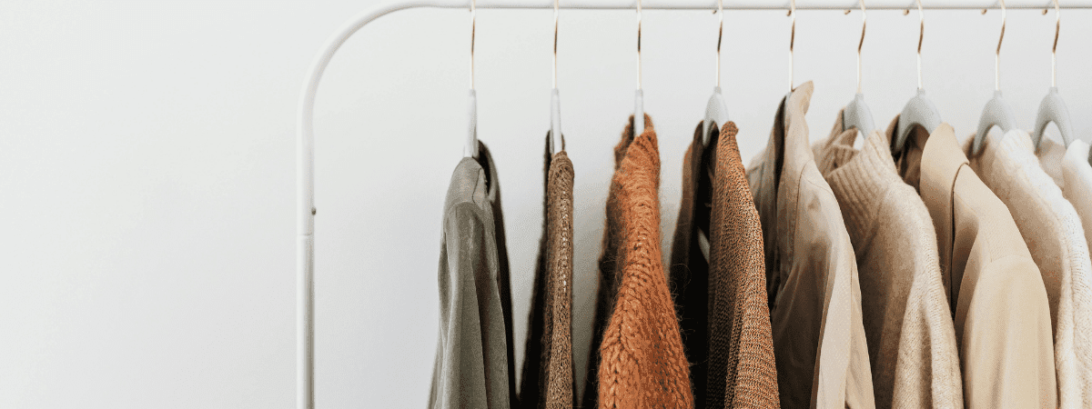warm earthy toned shirts hanging on a clothes rail