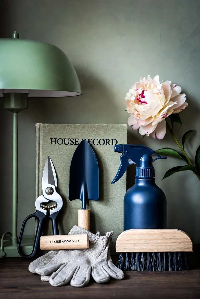 The house record book beside a toolkit on a sage cloth.