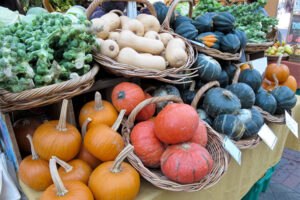 Various pumpkins, squash and other vegetables on display at a farmers market
